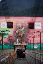 a mural of a woman holding a gun on the side of a building
