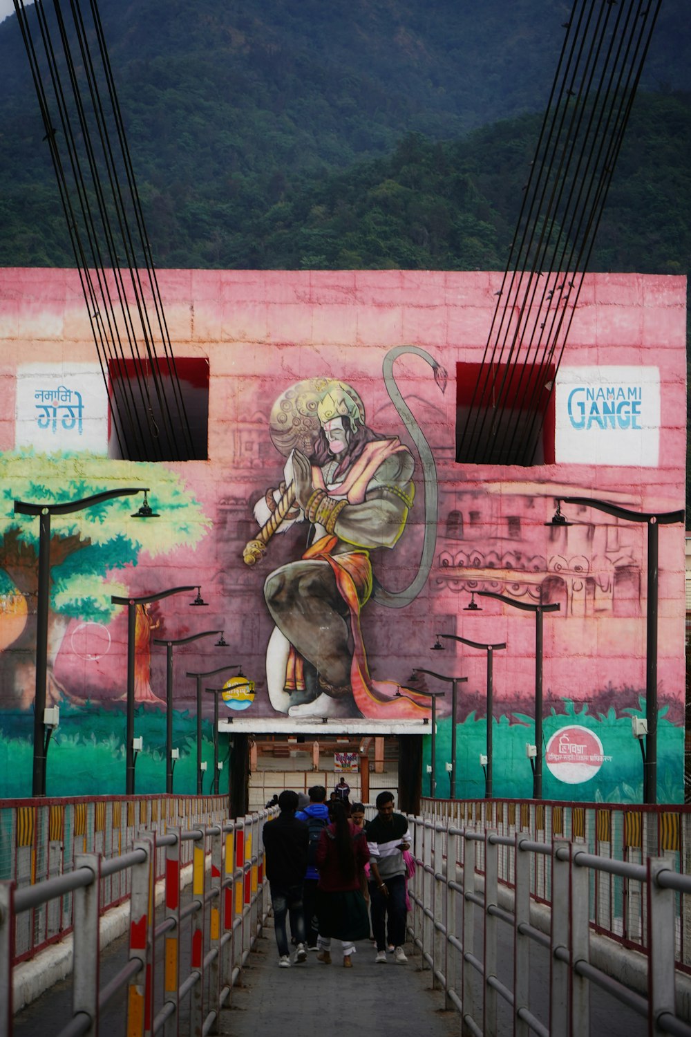 a mural of a woman holding a gun on the side of a building