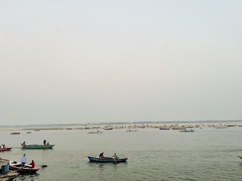 a group of boats floating on top of a large body of water