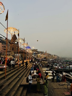 a group of people standing on top of a pier