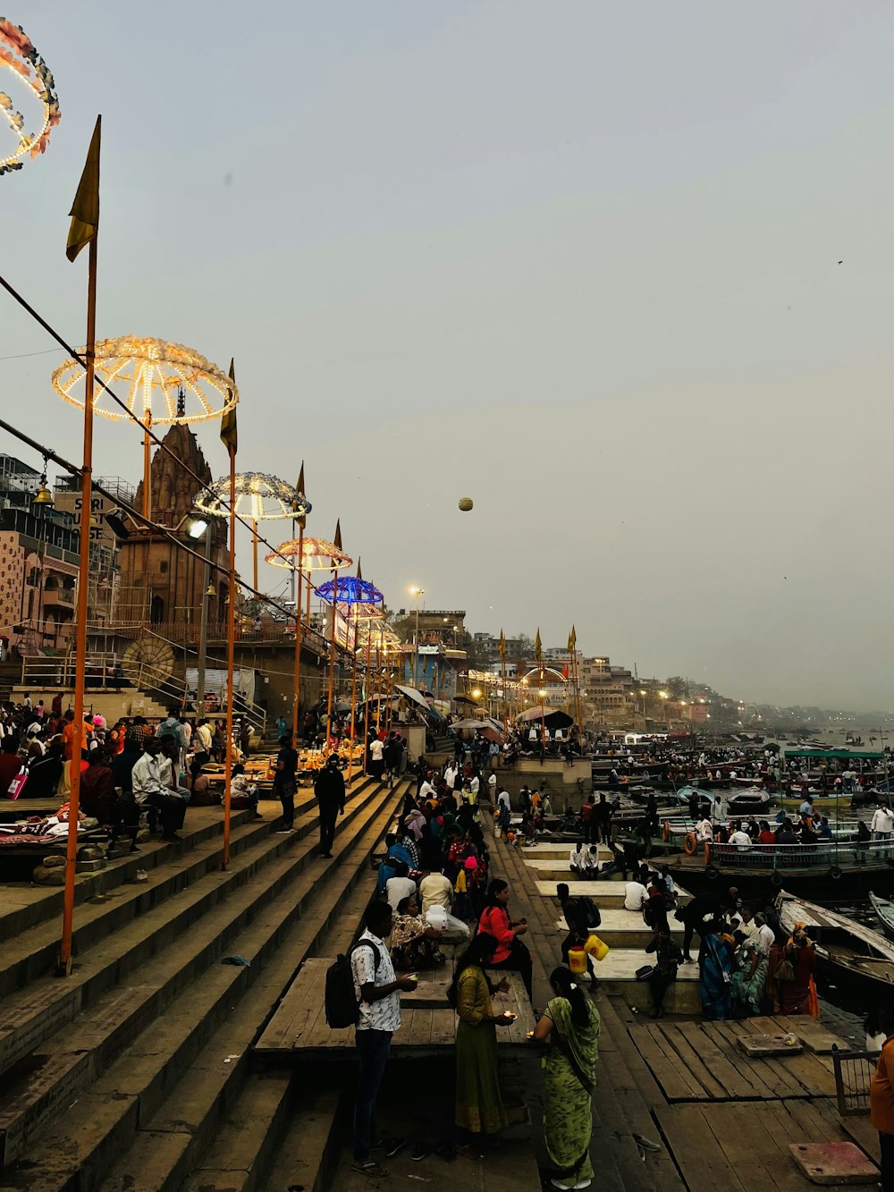 a group of people standing on top of a pier