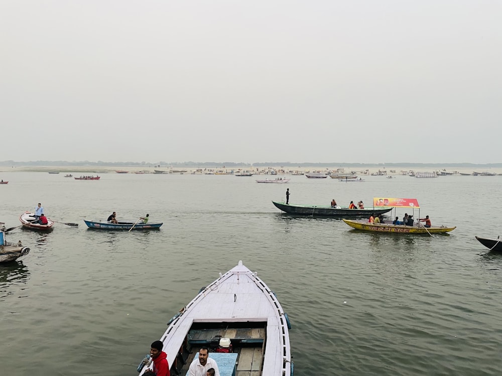 a group of boats floating on top of a large body of water