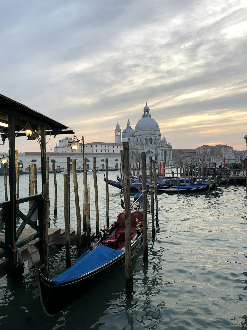 a row of gondolas sitting next to a pier