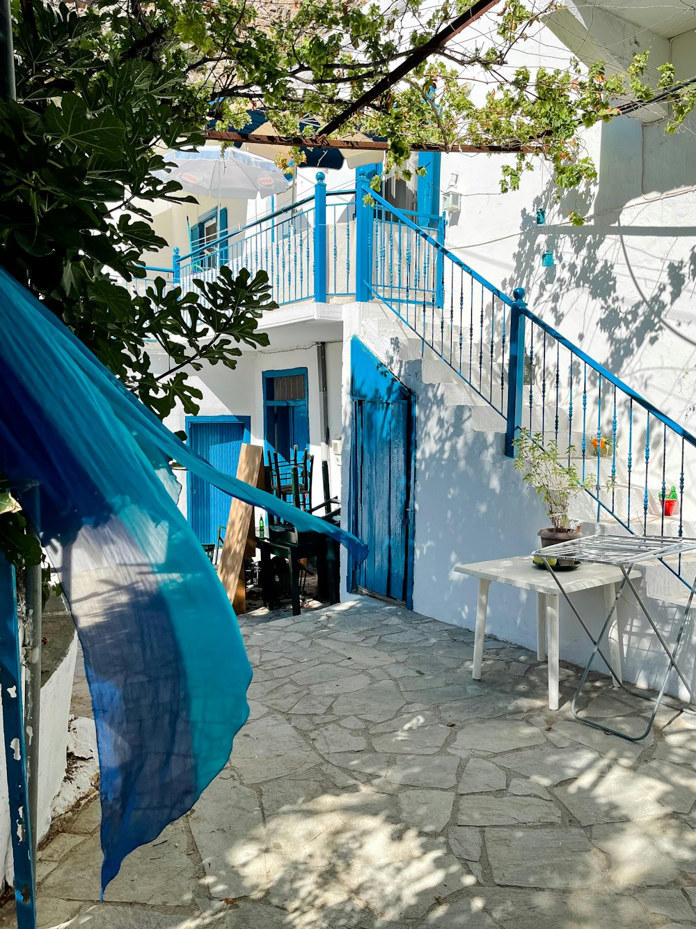 a white and blue house with a blue door