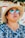 a woman wearing a straw hat and sunglasses