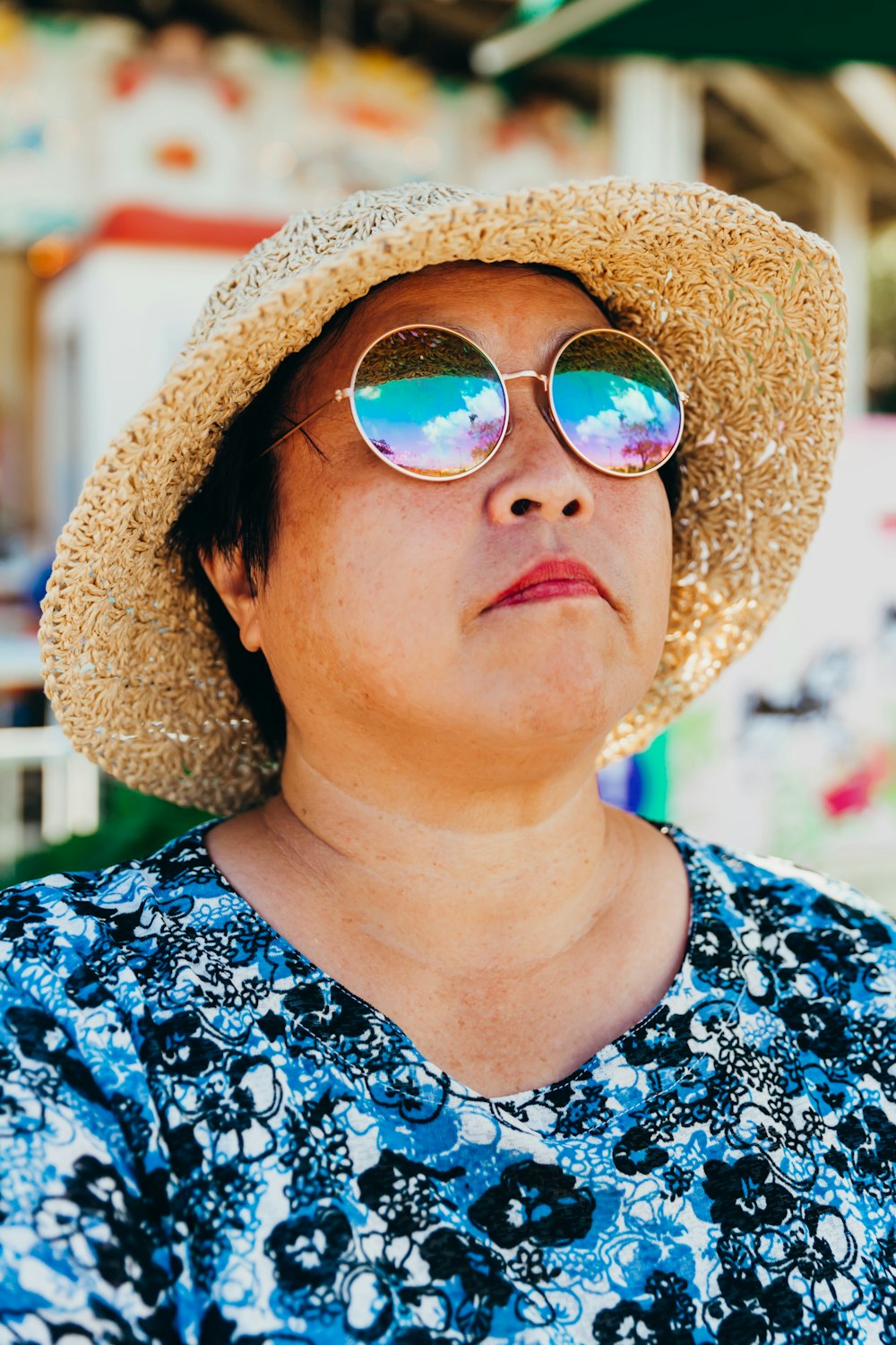 a woman wearing a straw hat and sunglasses