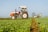 a tractor pulling a trailer behind it in a field