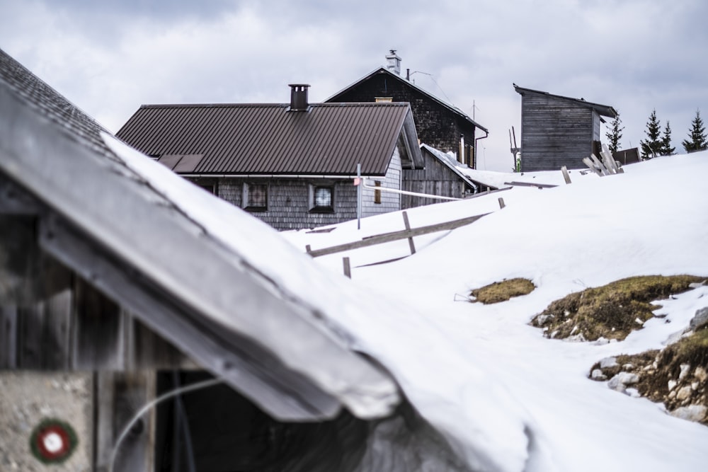 a snow covered roof with a building in the background