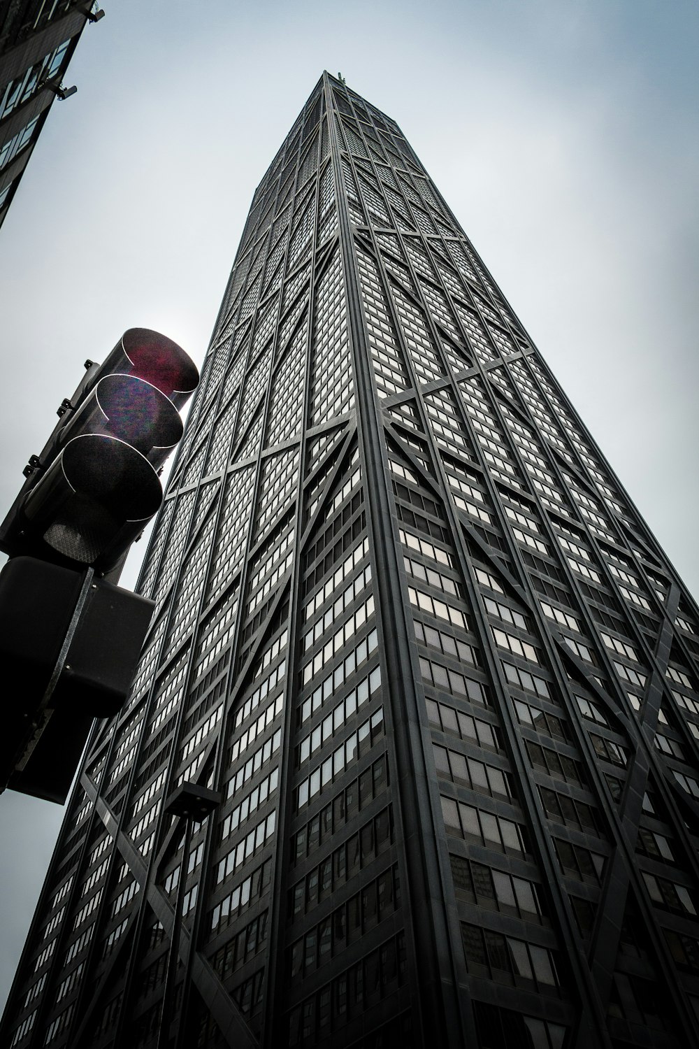 a tall building with a traffic light in front of it