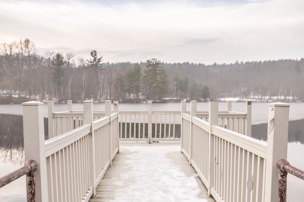 a white wooden bridge over a body of water