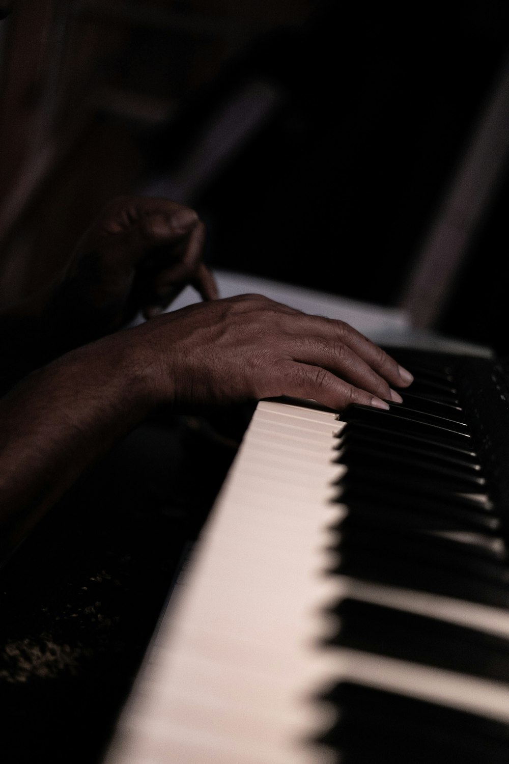 a close up of a person playing a piano