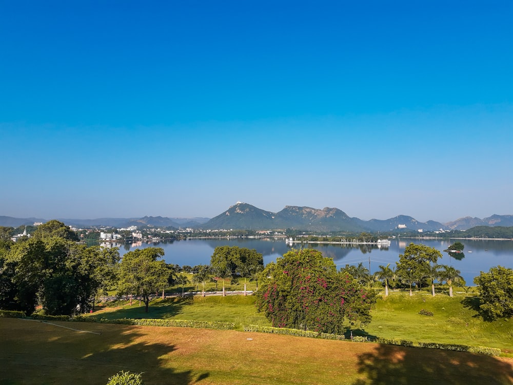 a scenic view of a lake and mountains in the distance