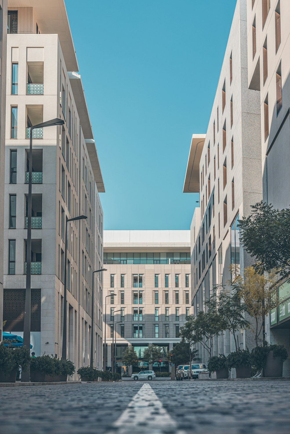 a city street lined with tall white buildings