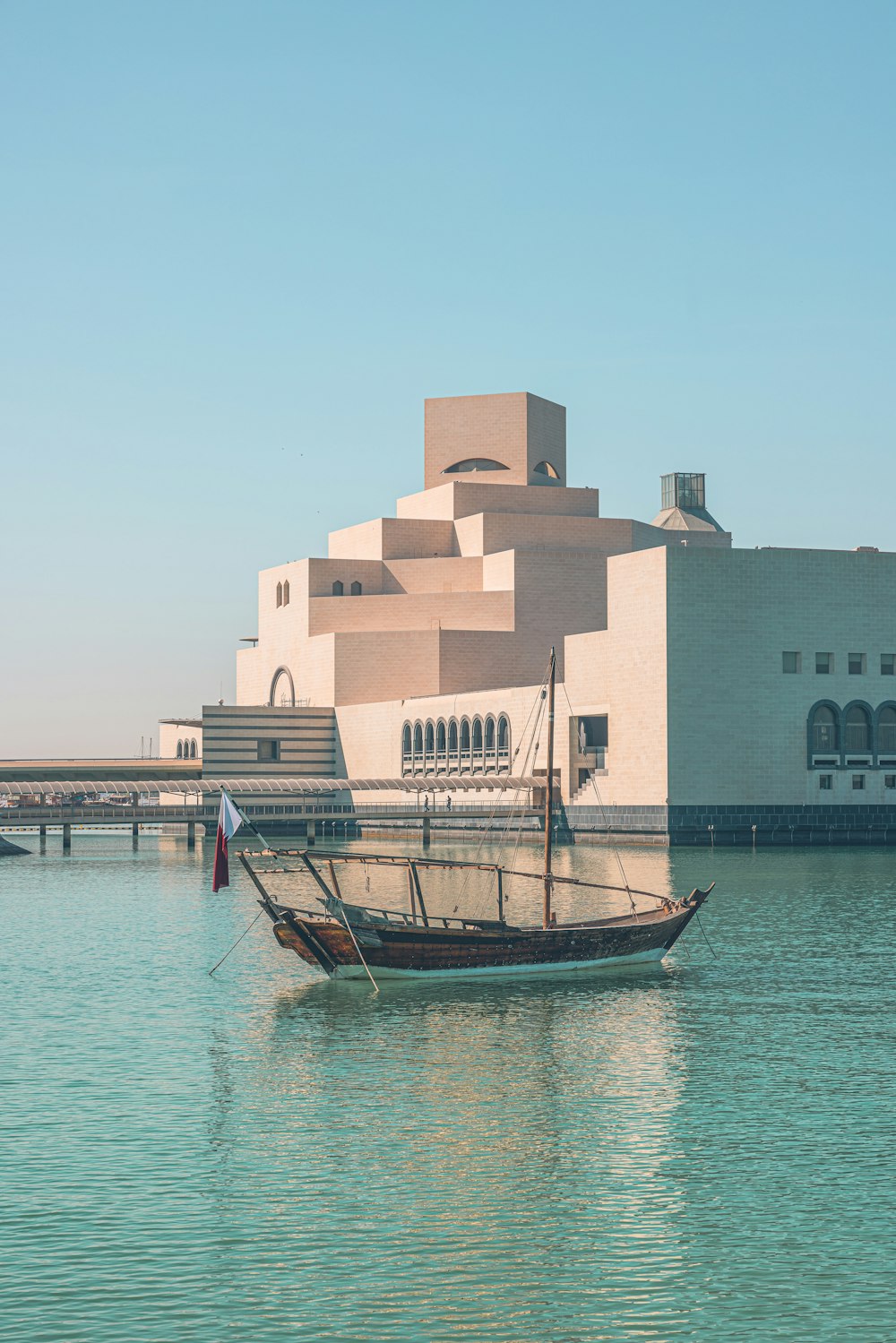 a boat in a body of water in front of a building