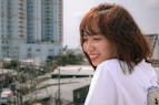 a woman standing in front of a city skyline