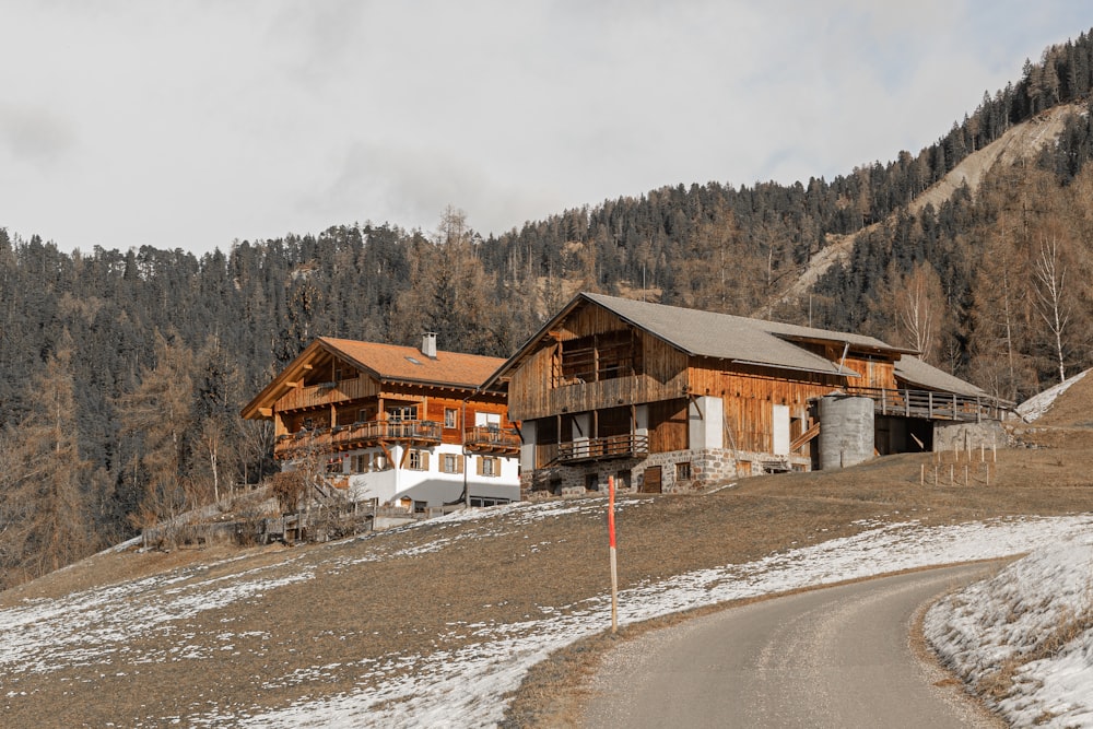 a house on the side of a road in the mountains