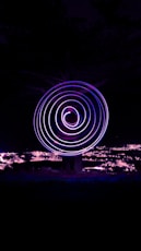 a spinning object in the dark with a sky background