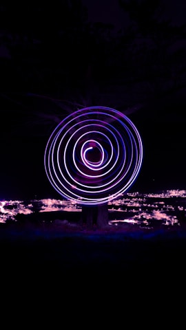 a spinning object in the dark with a sky background