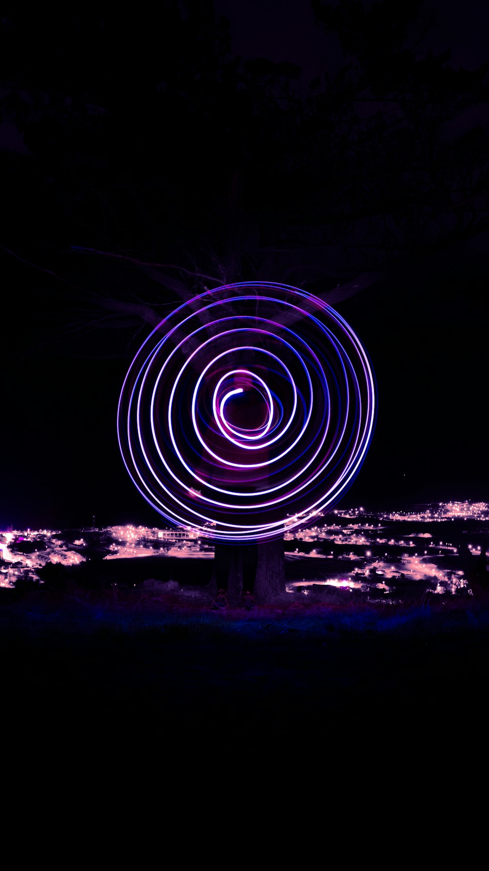 a spinning object in the dark with a sky background