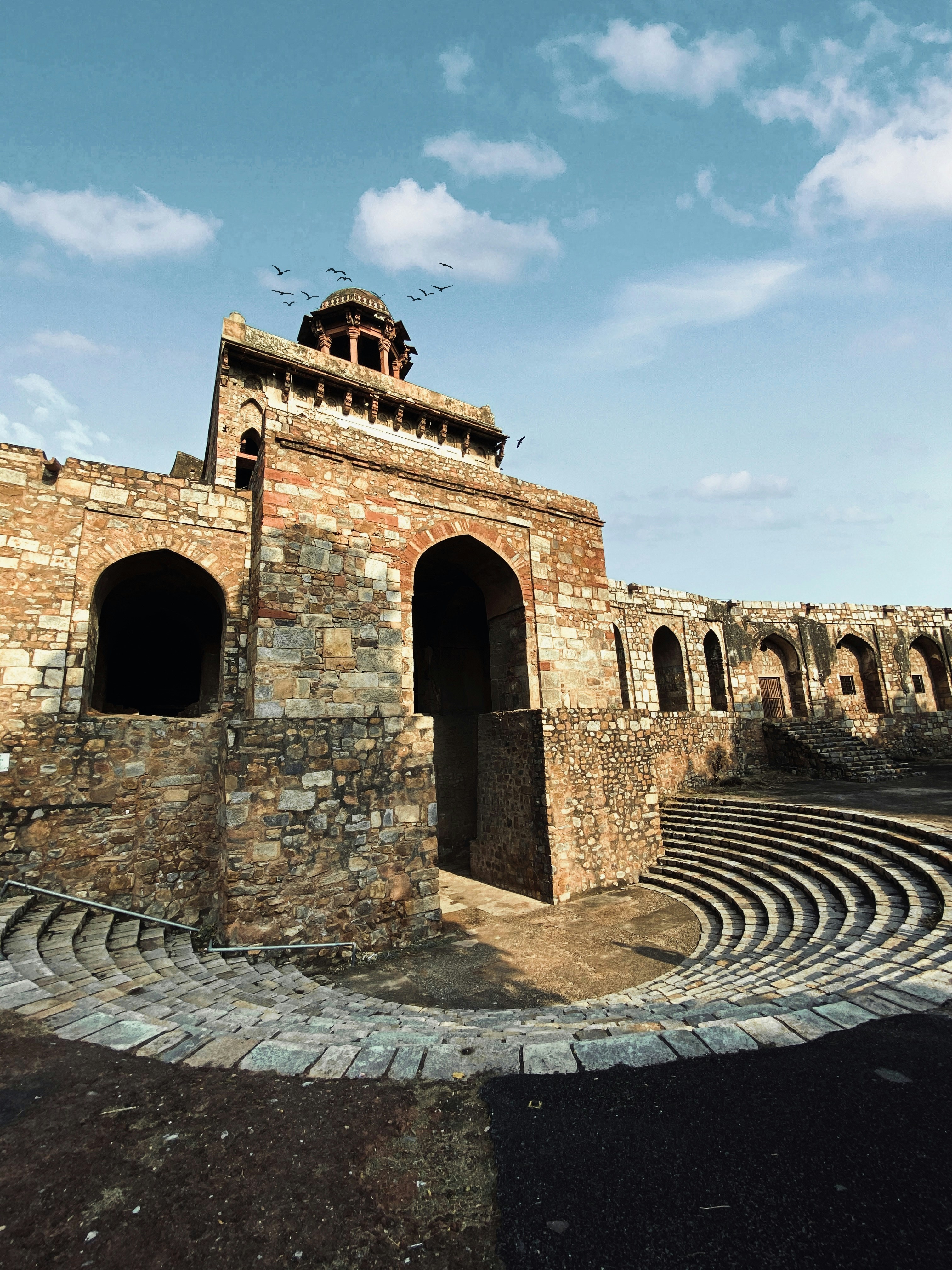 a stone building with a clock tower on top of it