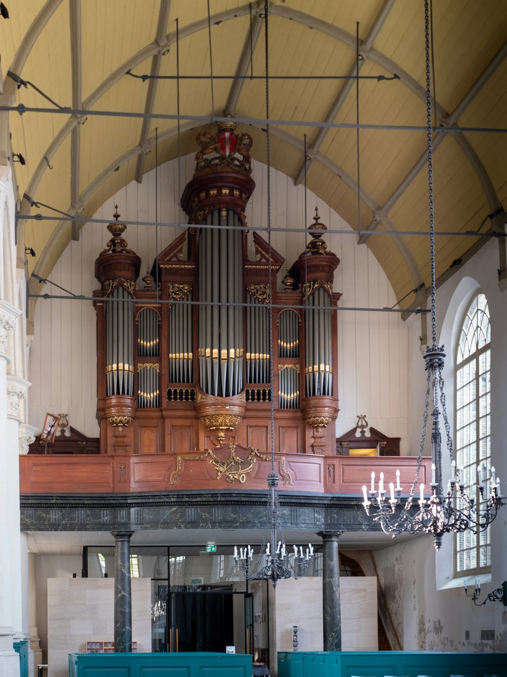 a pipe organ in a church with a chandelier