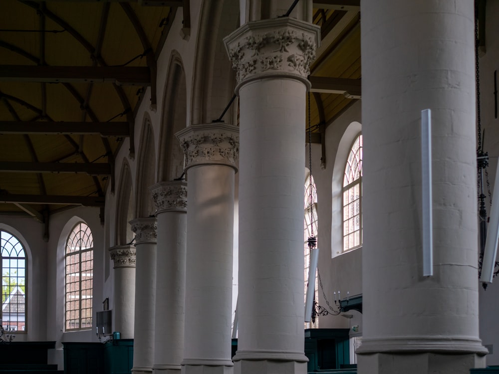 a row of white pillars in a large building