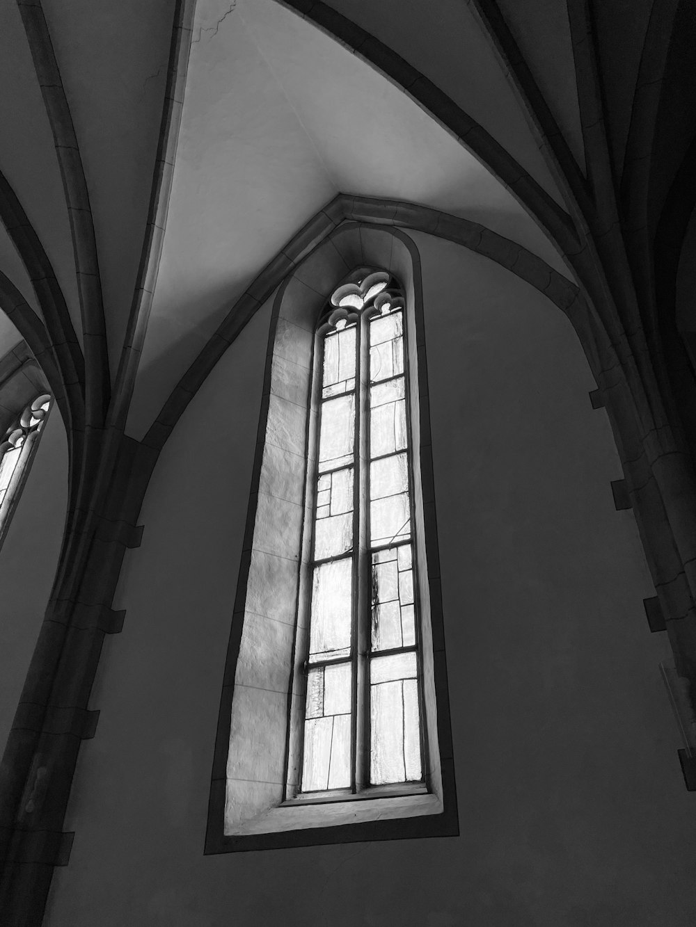 a black and white photo of a stained glass window