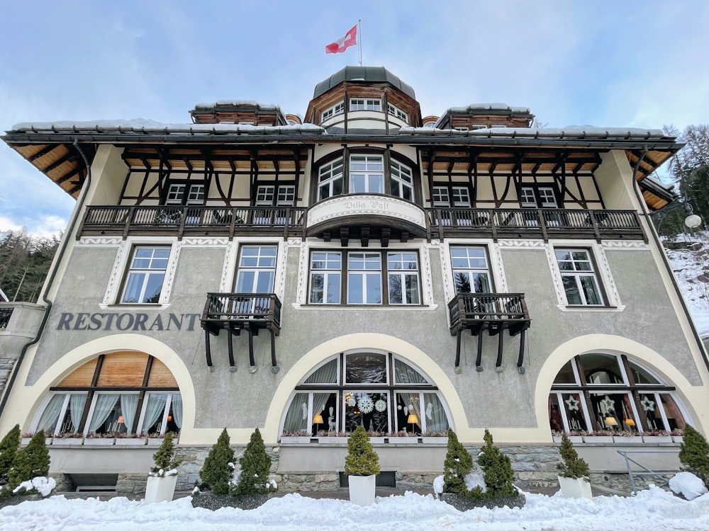 a large building with lots of windows and a flag on top of it