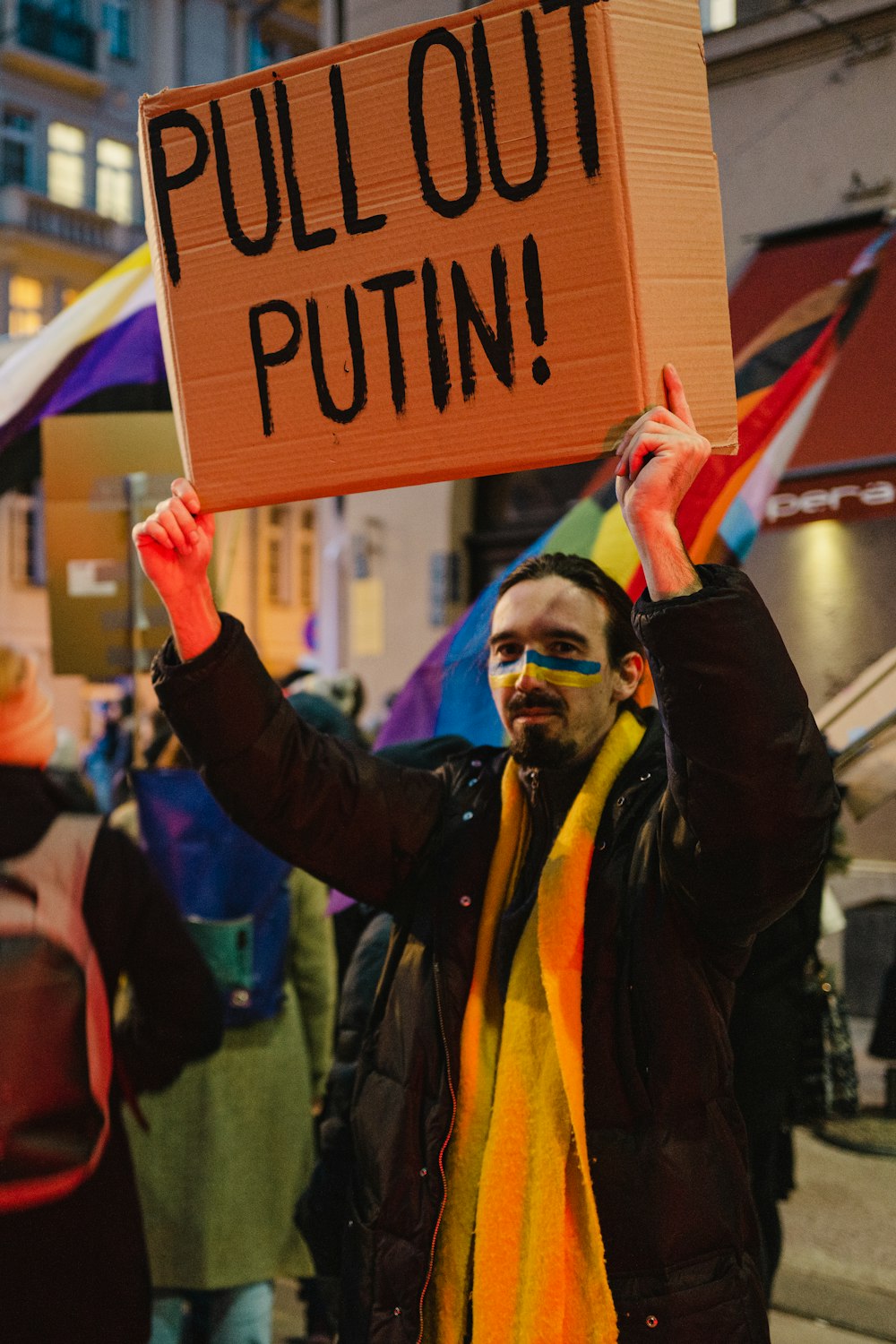 a man holding a sign that says pull out puttin