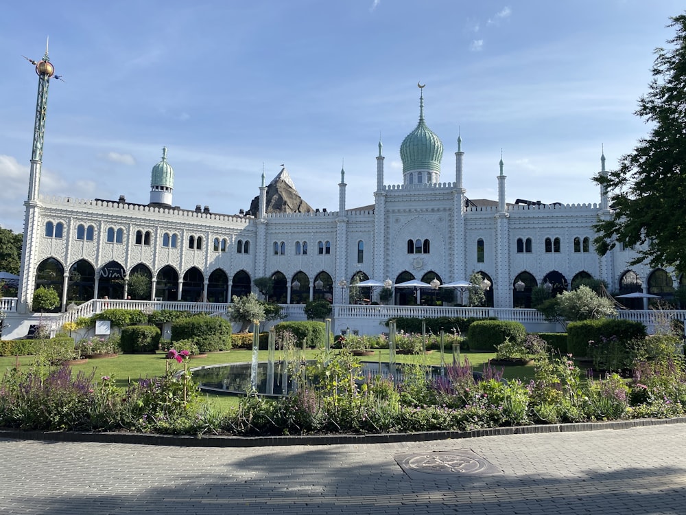a large white building with a green dome