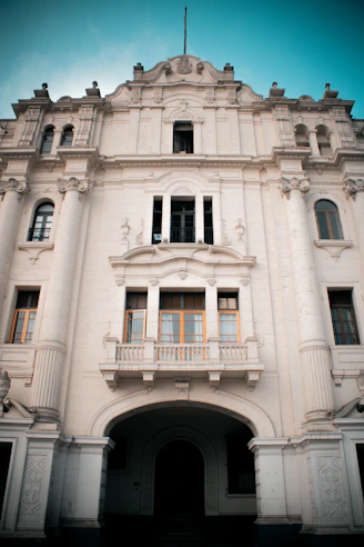 a large white building with many windows and balconies