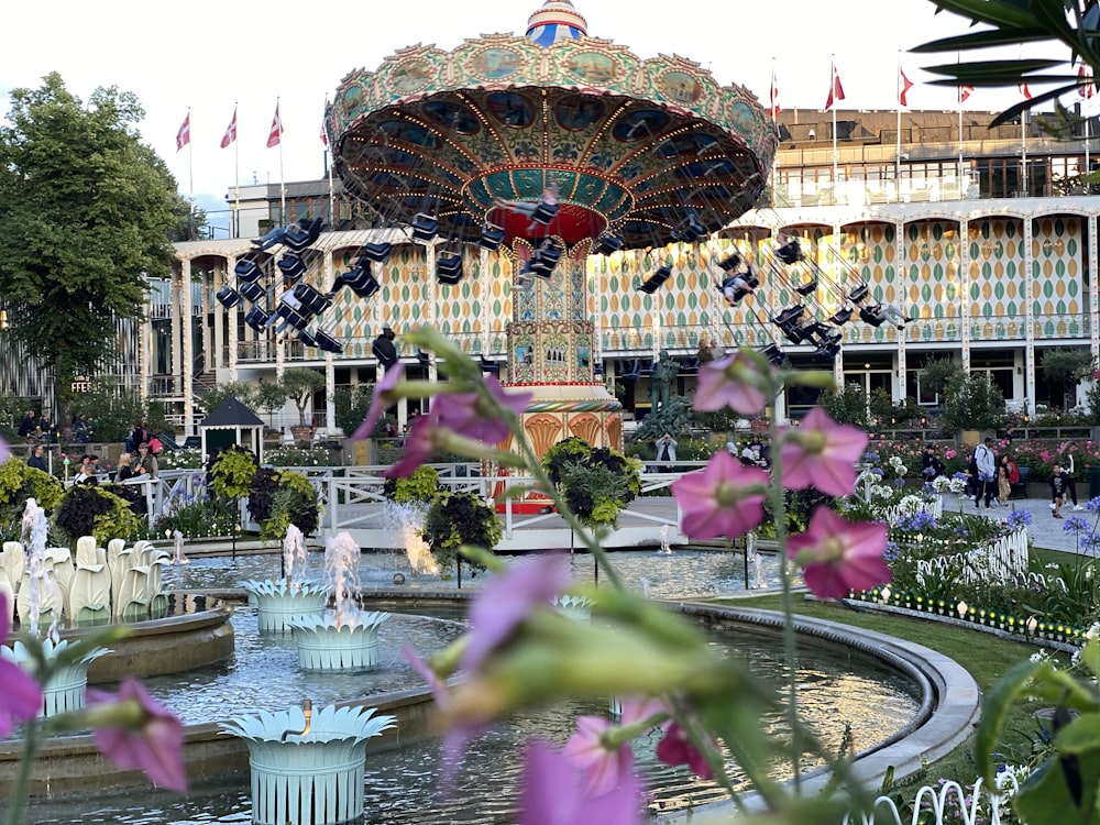 a fountain with a carousel in the background