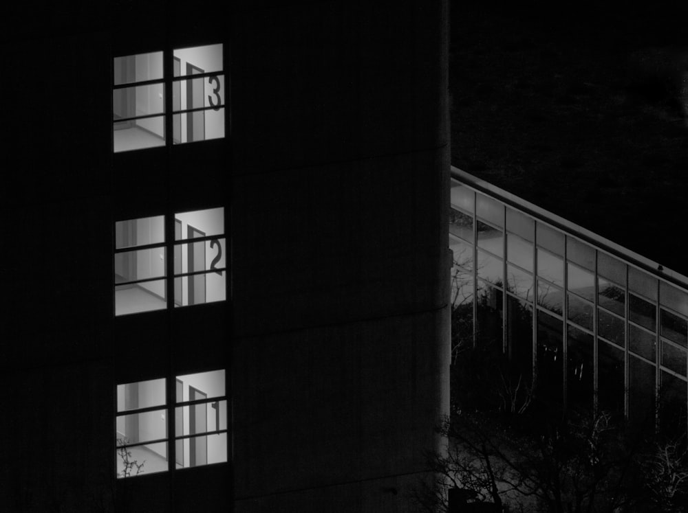 a tall building with windows lit up at night