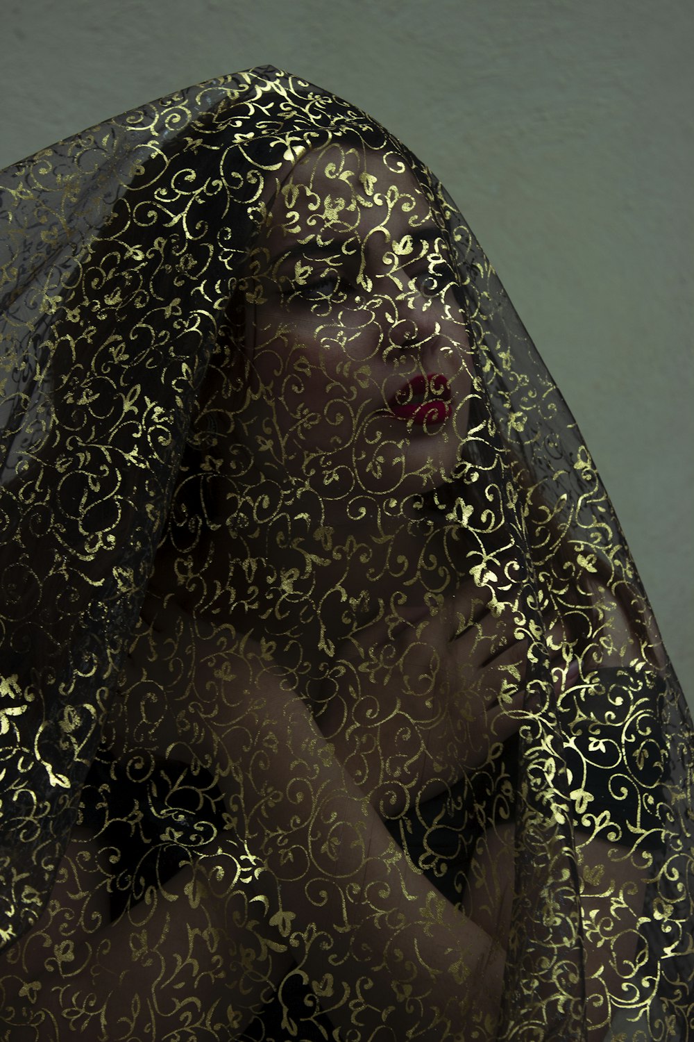 a woman with a veil covering her face