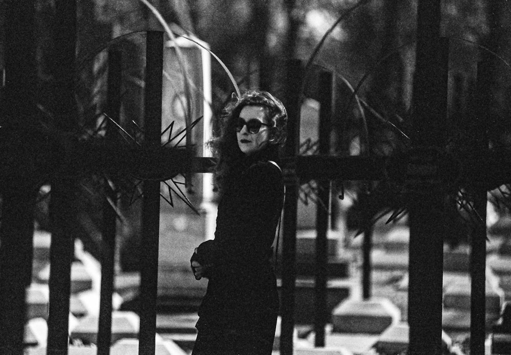 a black and white photo of a woman wearing sunglasses