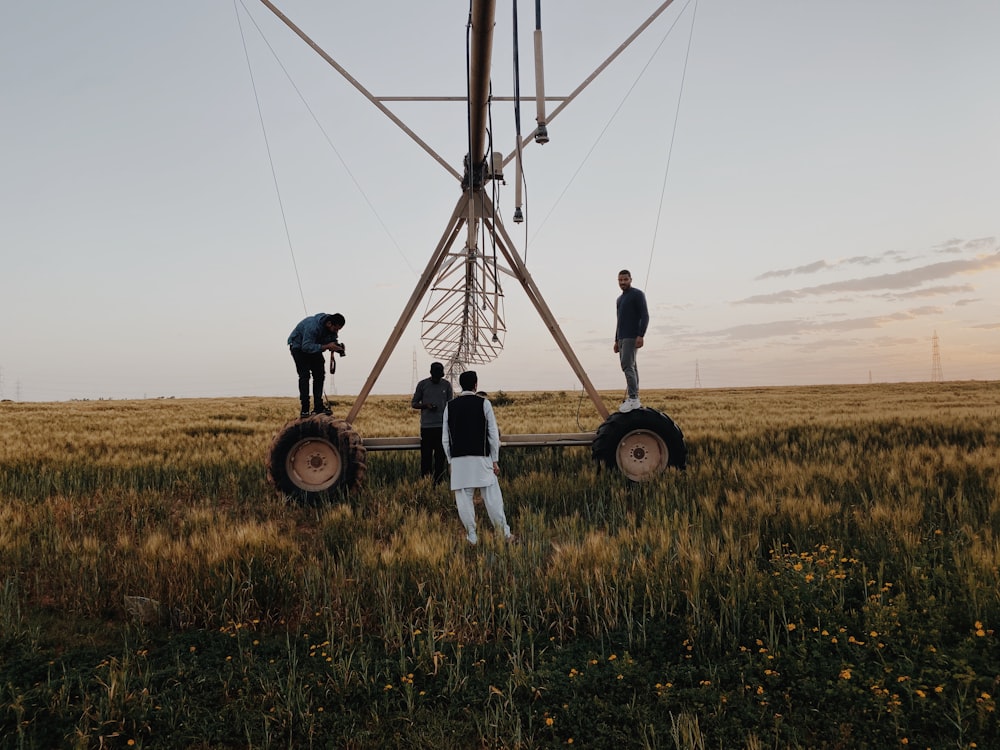 a group of men standing on top of a grass covered field