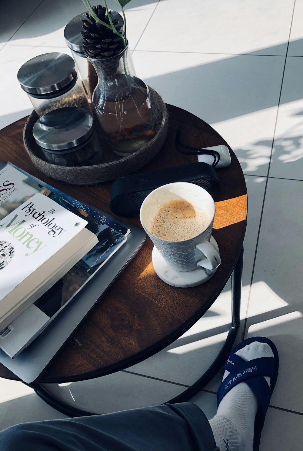 a coffee table with a book and a cup of coffee