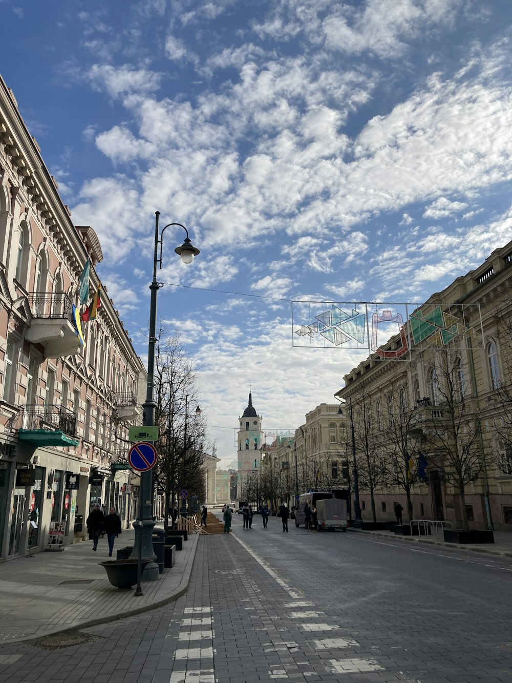 a city street with people walking down it