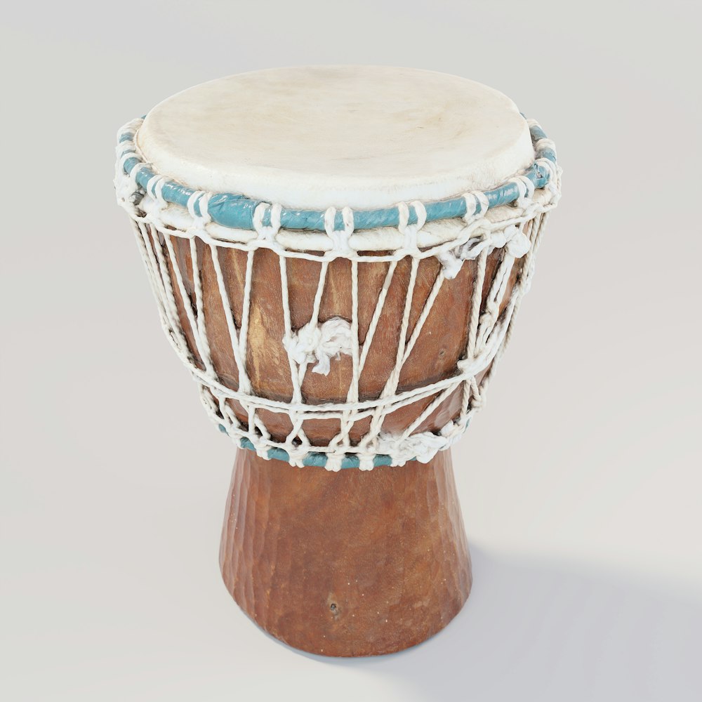 a small wooden drum with a string wrapped around it