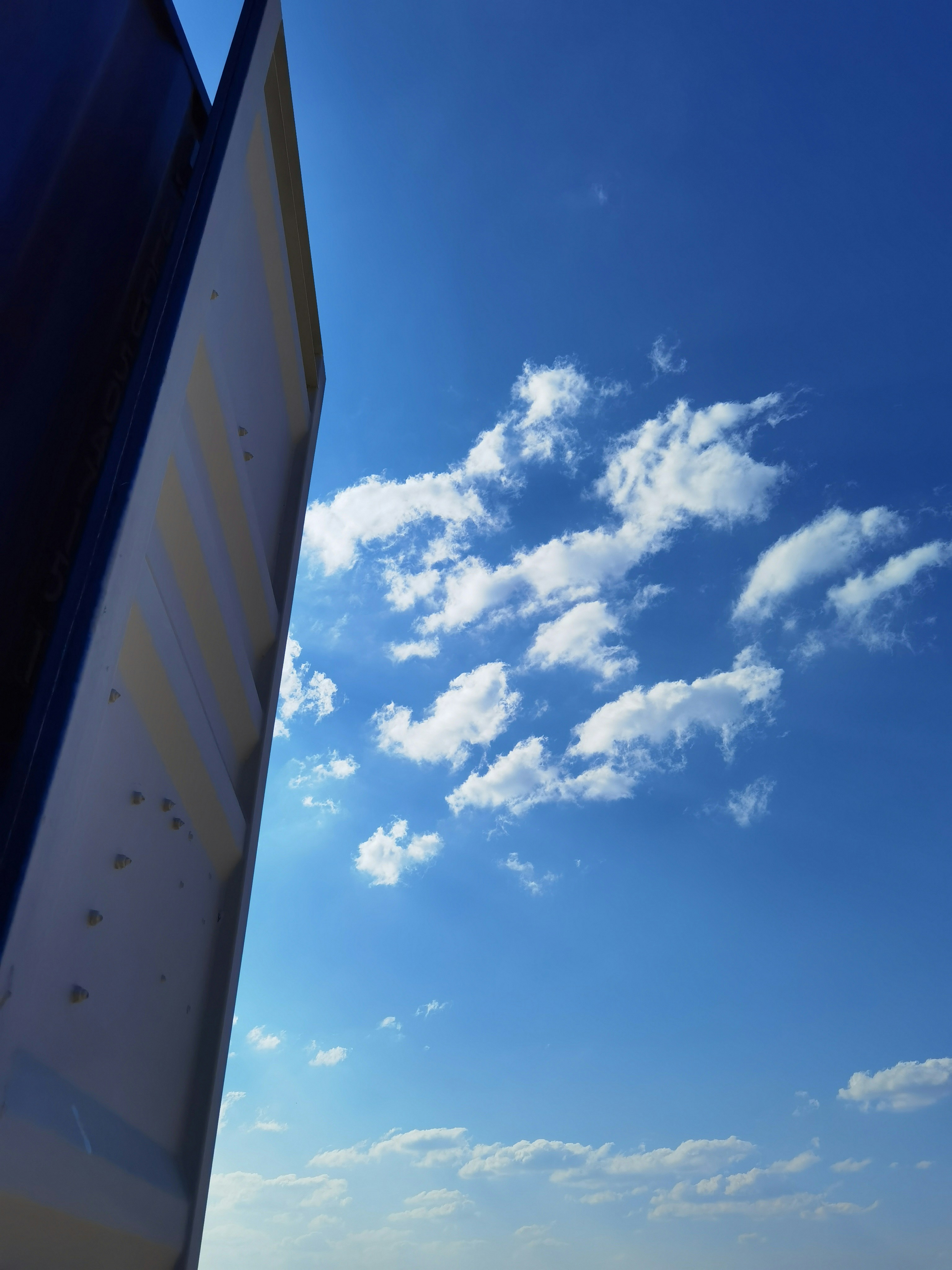 A plane flying through a blue sky with white clouds photo – Free Blue ...