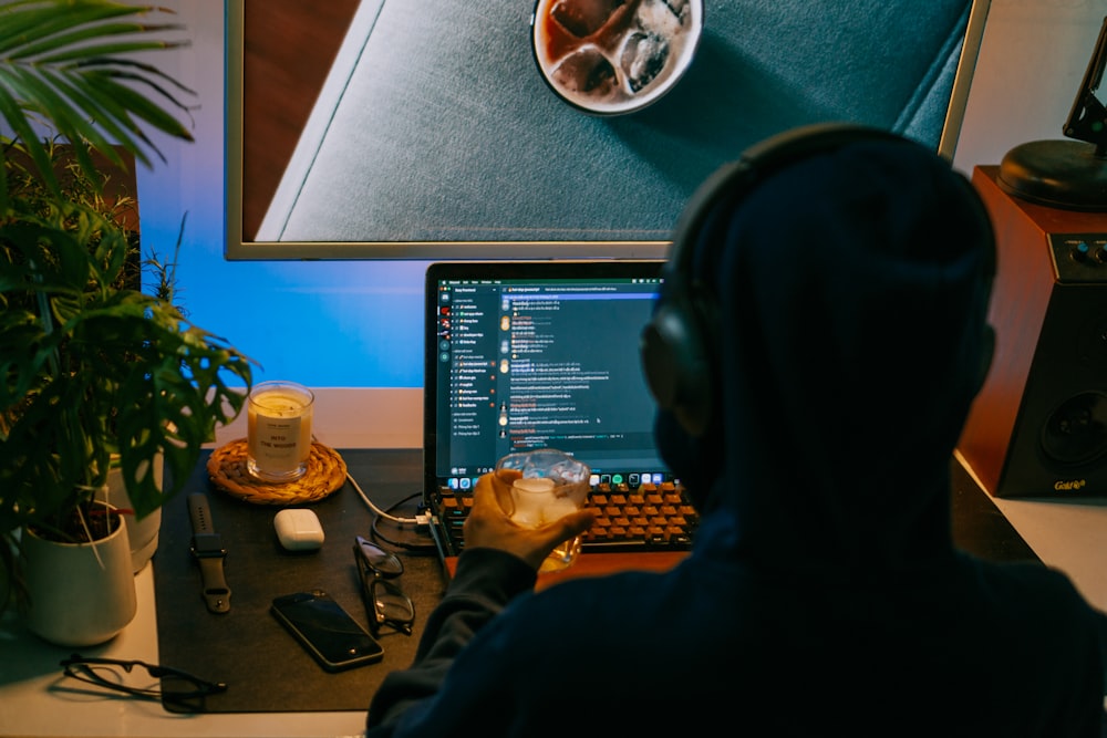 a person sitting at a desk in front of a computer