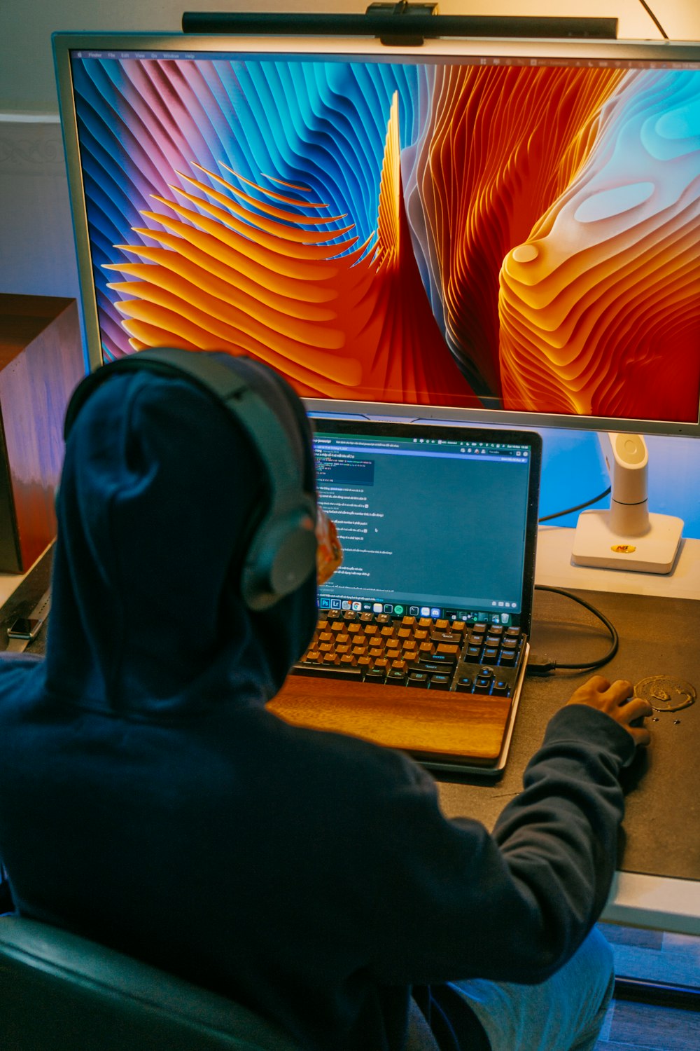 a man sitting in front of a laptop computer