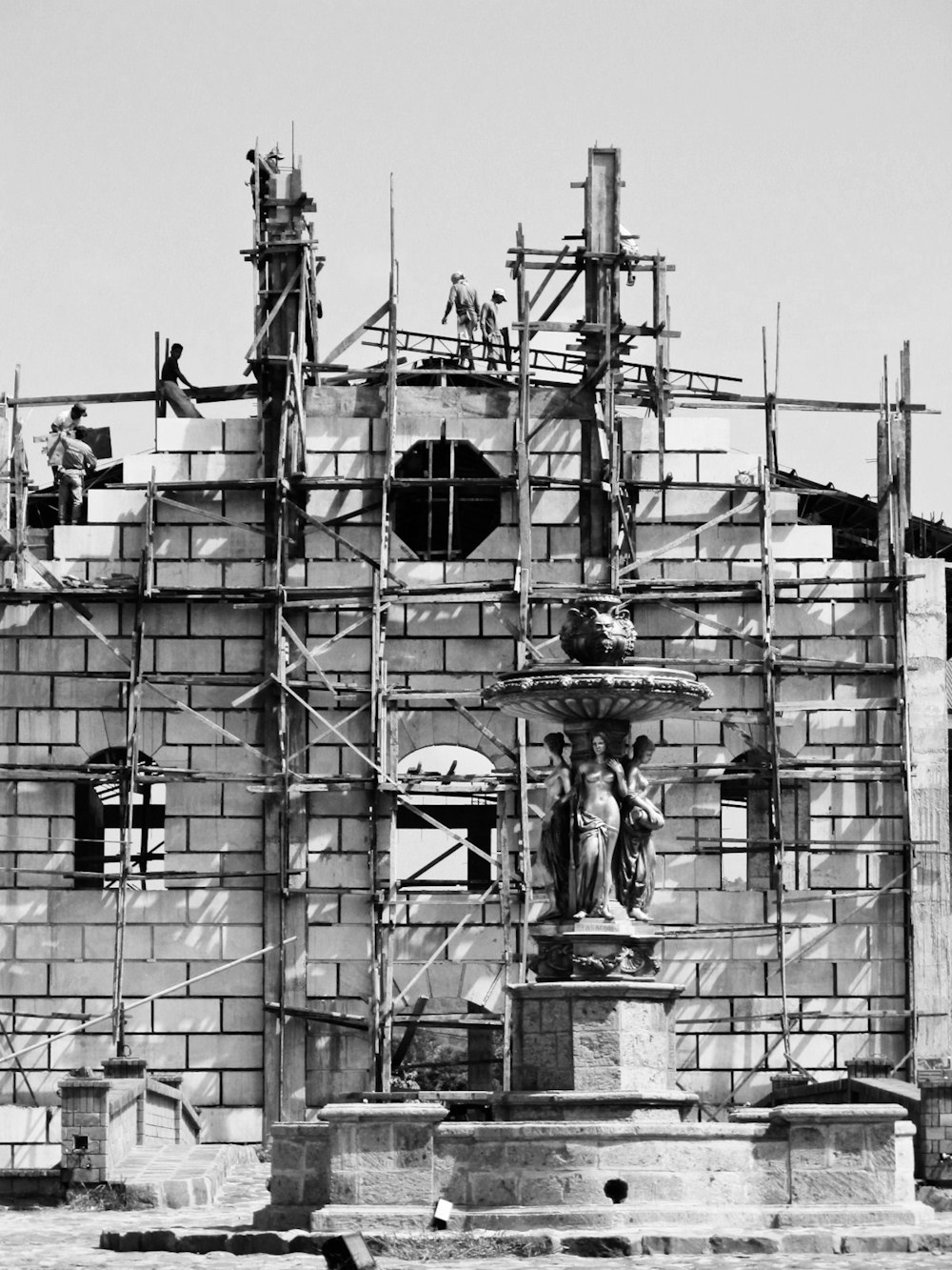 a black and white photo of a building under construction