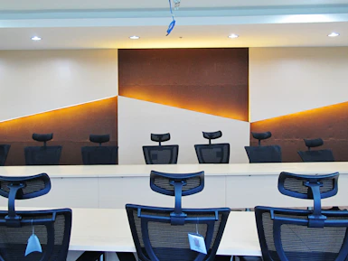 a conference room with chairs and a large painting on the wall