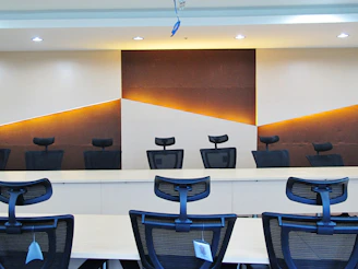 a conference room with chairs and a large painting on the wall