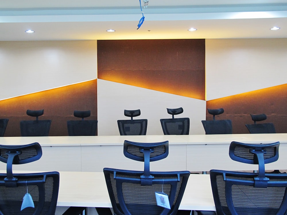 a conference room with chairs and a large painting on the wall