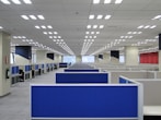 an empty office with blue and white cubicles