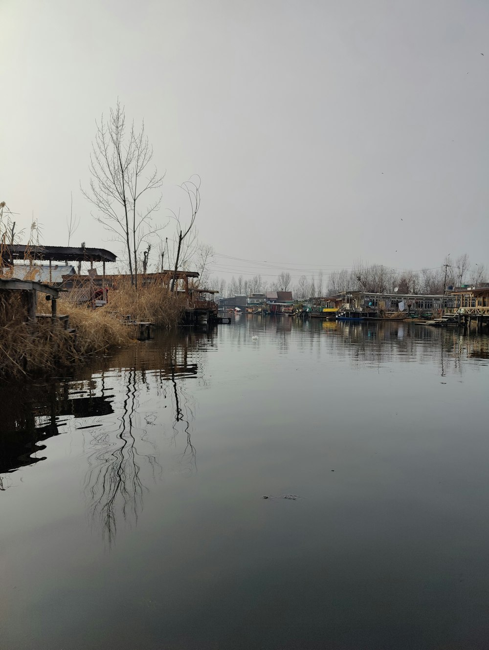 a body of water with a bridge in the background