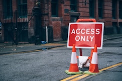 a red and white sign sitting on the side of a road