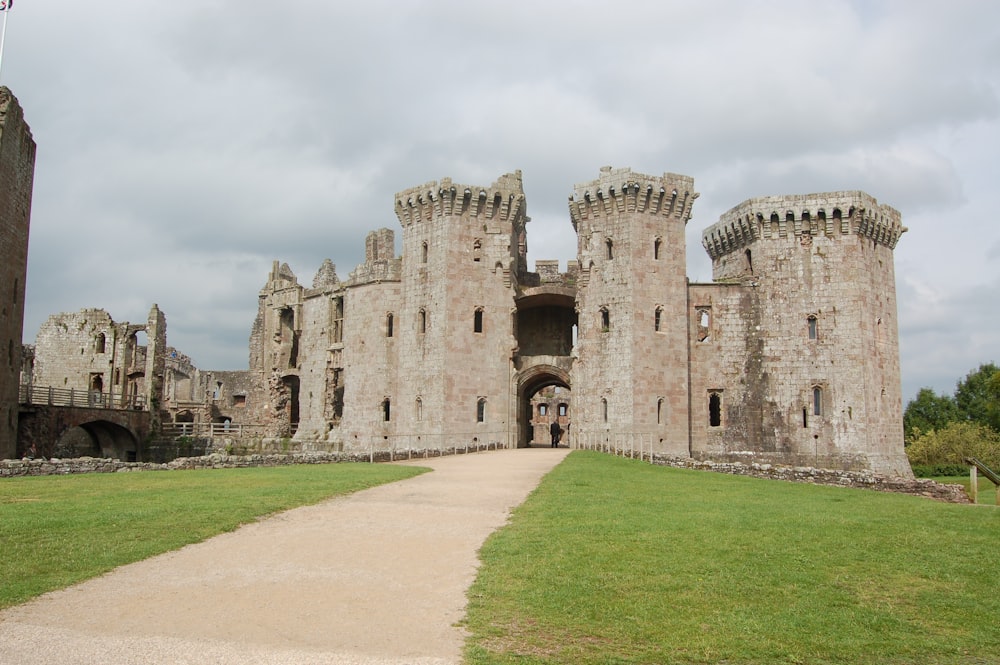 an old castle with a walkway leading to it